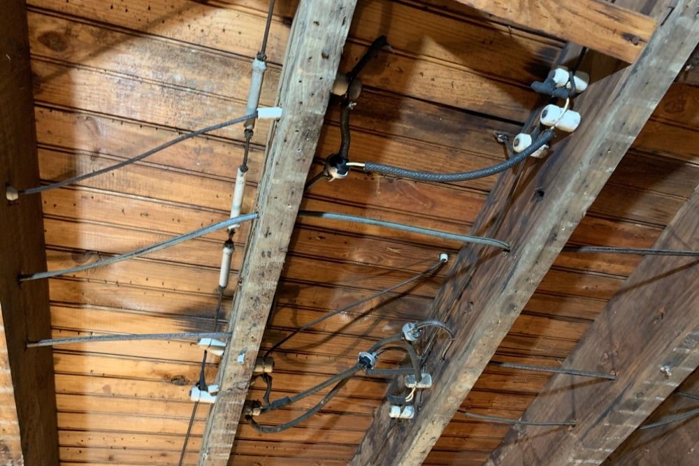 Old knob-and-tube wiring being replaced with modern wiring by Archvolt Electric