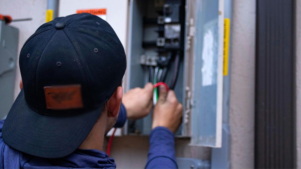 Archvolt Electric technician troubleshooting an electrical service panel